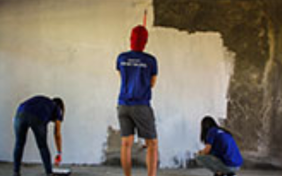 Security Bank employees paint school building donation in Davao Del Norte